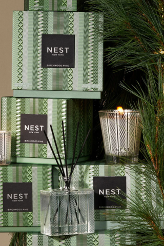 NEST diffusers and candles displayed with greenery